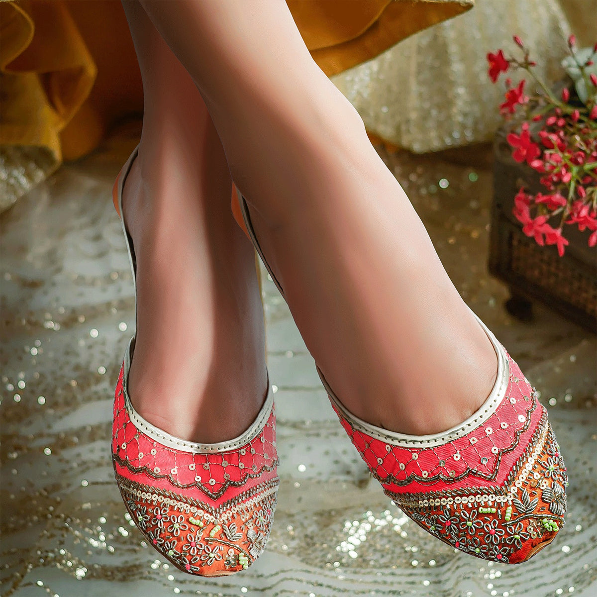 Discover handmade Khussa shoes for women, epitome of tradition with vibrant orange and yellow silk adorned with sequins. Ideal for weddings and events.